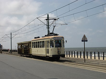 One of the many trams preserved by TTO, pulling two open carriages during a parade in celebration of 125 years of tramways along the coast, pictured near Middelkerke.