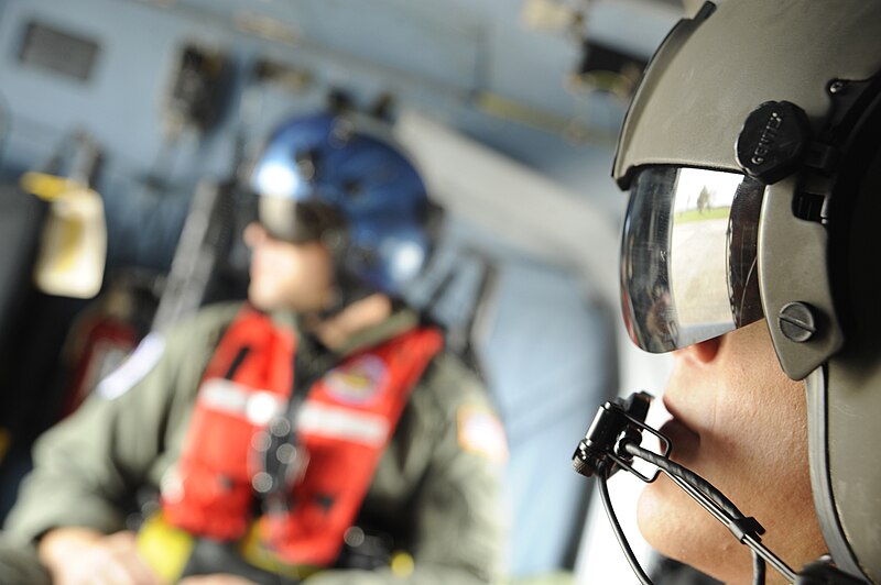 File:Two Coast Guard rescue swimmers preparing to take off in a helicopter.jpg