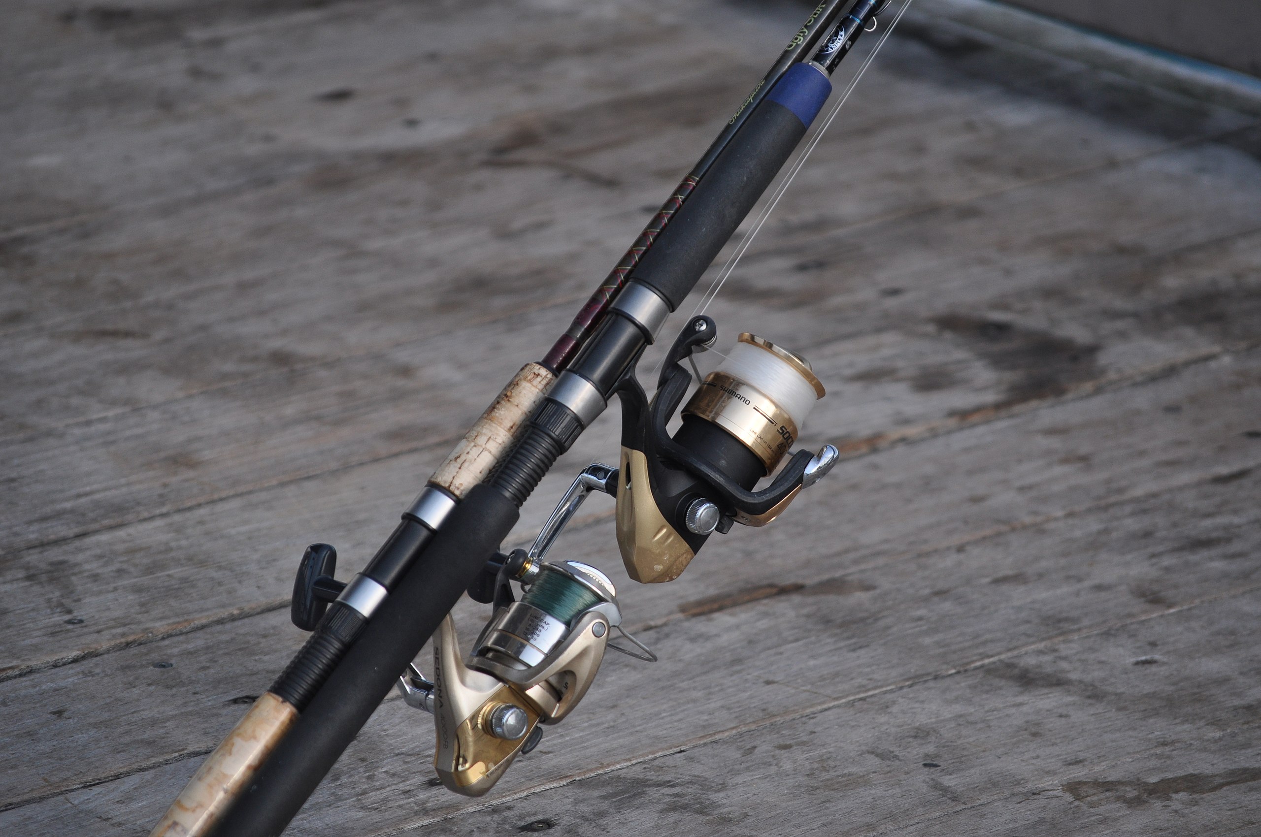 File:Two spinning fishing reels on pier.JPG - Wikimedia Commons
