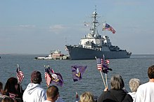 USS McFaul flying her battle ensign as she returns to Naval Station Norfolk, Virginia from deployment. US Navy 061114-N-2248M-005 Families and friends wait on the pier as the guided-missile destroyer USS McFaul (DDG 74) arrives into port at Naval Station Norfolk after a six-month deployment.jpg