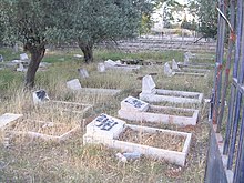 A vandalized Christian graveyard in Bethlehem. The text says "Death to Arabs" in Hebrew. Vandalized graveyard.jpg