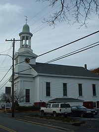 The First Congregational Church of Wellfleet. The clock tower (referred to as "Town Clock") is equipped with a ship's signal bell system. Wellfleet Congregational Church.jpg