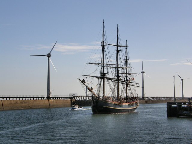 Replica of HMS Bounty, as used in the film Mutiny on the Bounty entering Blyth Harbour, 4 September 2007 with a turbine from the Blyth Harbour breakwa