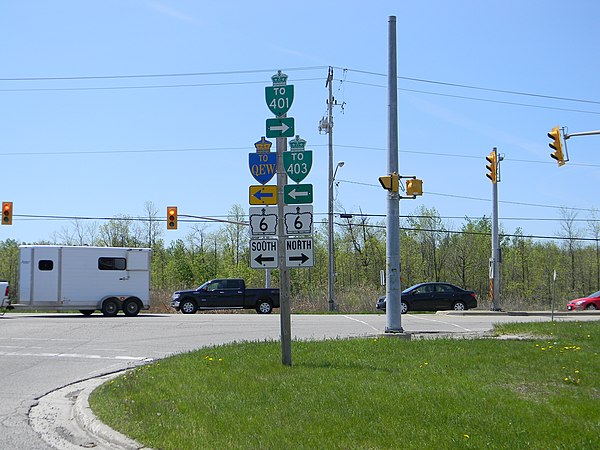This marker assembly at an intersection with Highway 6 features junction crowns and trailblazer shields directing traffic to several highways, and ill