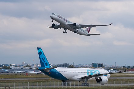 An Airbus A330neo and a Qatar Airways Airbus A350-900 at Toulouse-Blagnac Airport
