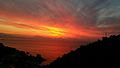 Il sole sorge dietro i monti del Cilento riflettendo i suoi raggi sul mare di Erchie