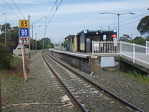 Belambi Railway station looking from rail crossing.jpg