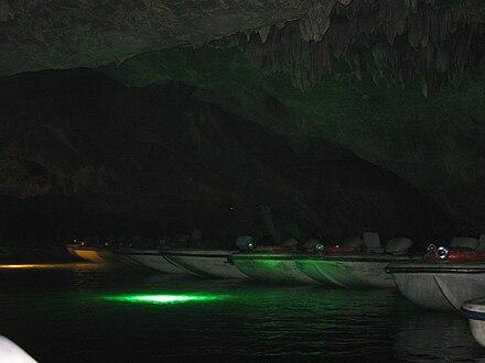 Boat ride atop crystal clear water of Benxi Watercave National Park