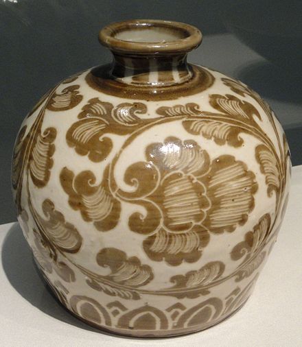 Song dynasty Ding porcelain bottle with iron pigment under a transparent ivory-toned glaze, c. 1100.  Both the closed shape and the painted underglaze decoration are uncommon in Ding.