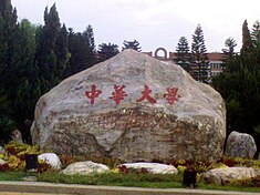 Kamenná stéla, v pozadí budova univerzity