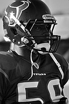Black and white photograph of DeMeco Ryans in his Houston Texans uniform and helmet.
