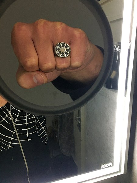 File:Fist in mirror with chaos magic finger ring.jpg