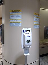 Hand sanitizer and signs about COVID-19 at Los Angeles International Airport Hand sanitizer and signs at McCarran International Airport.jpg