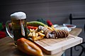 Homemade traditional Serbian Karadjordje`s sausage with a glass of cold refreshing beer in the restaurant. (49175116362).jpg