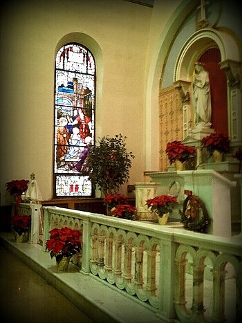 The Mary Altar/Shrine at Immaculate Conception Church in Northern Liberties, Philadelphia, decorated for Christmas . Immaculate Blessed Mother Altar and Stained Glass Window.jpg