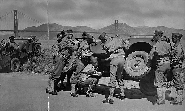 Soldiers manhandle jeep as intended, to fix it. Golden Gate Park, San Francisco.