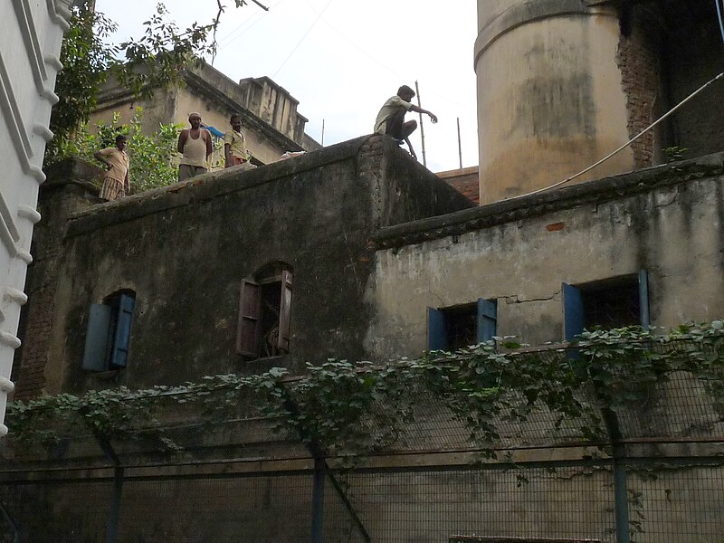 File:Men on building next to St. John's Church, Calcutta - Nov 2010.jpg
