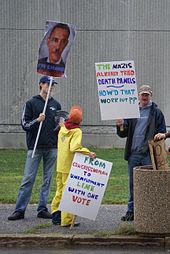 Protesters referencing the phrase "death panel" at a town hall meeting Protest banners with picture of Obama with Hitler mustache and a death panel sign.jpg