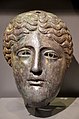 Roman bronze mask from a cavalry helmet of the Silistra type in the style of a goddess centrally parted locks of wavy hair, 1st - 2nd century AD, Mougins Museum of Classical Art, France.jpg