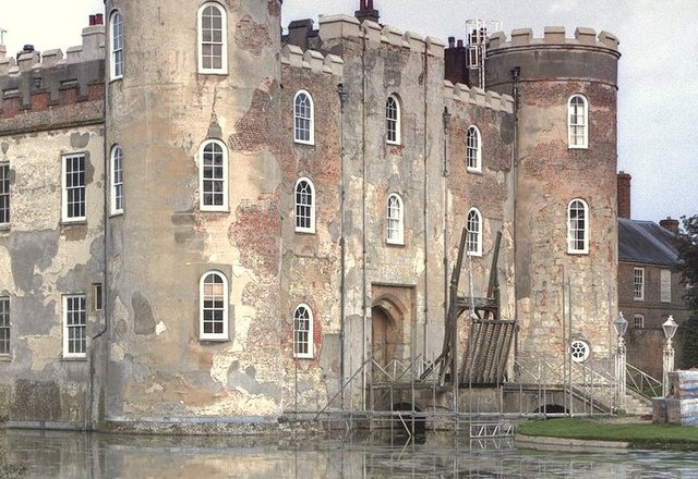 Detail of the west front in 2014, showing construction materials revealed by loss of the external render, and the early nineteenth century drawbridge 