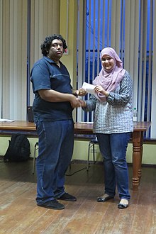 Khan receiving a chess award from Aneesa Maryam Hussain TKJNC.jpg