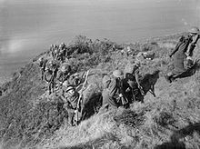 Men of the 2nd Battalion, London Irish Rifles advancing with fixed bayonets after climbing up the cliffs during training at Little Haven near Haverfordwest. The British Army in the United Kingdom 1939-1945 H5139.jpg