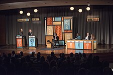 Taping Wait Wait...Don't Tell Me! at the Chase Auditorium in Chicago. Left to right, Bill Kurtis, Peter Sagal, US Secretary of Labor Thomas E. Perez, and panel, Paula Poundstone, Luke Burbank, and Faith Salie.