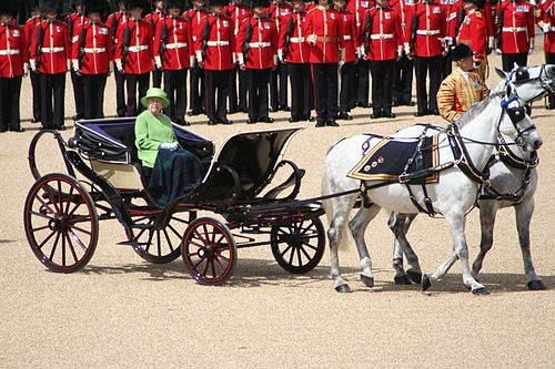 The Queen riding in a Phaeton, drawn by Windsor Grey horses, at the 2007 Trooping the Colour. (This carriage is known as the "Ivory-mounted Phaeton".)