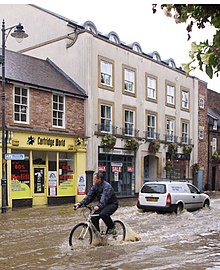 Urban flooding in a street in Morpeth, England Urban flood cropped.jpg