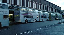 Shuttle buses waiting for students to embark in Mansfield town centre Vision West Nottinghamshire College shuttle buses.jpg