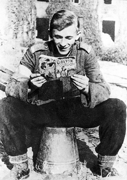 A young corporal of the Home Army reading a Polish edition of one of Flash Gordon ("Błysk Gordon - Królowa Błękitnej Magii") graphic novels during the