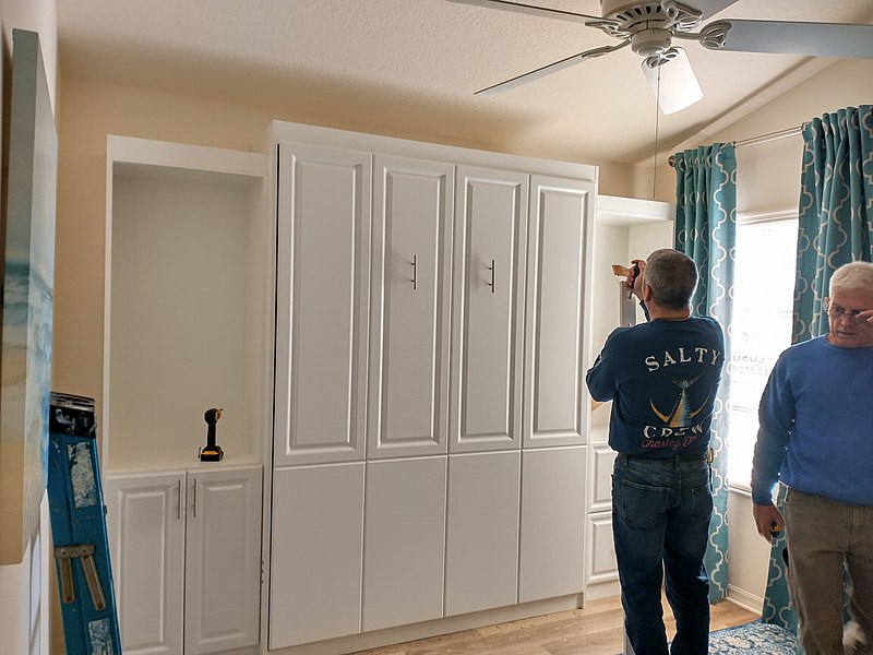 File:Workmen installing a wall bed.jpg