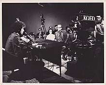 "Tombstone Blues" has been described as folk rock. At this press conference in December 1965, Bob Dylan (pictured left) denied playing folk-rock and said "I like to think of it more in terms of vision music - it's mathematical music." Zagone Dylan Press Conf.jpg