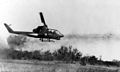 AH-1 Cobra firing rockets at enemy target