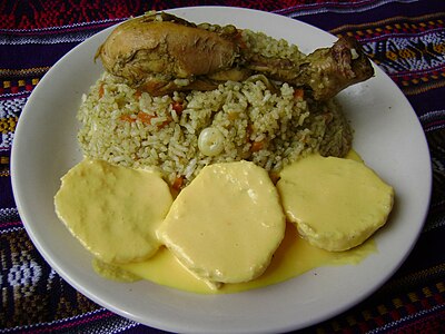 Homemade arroz con pollo and papas a la huancaína (bottom), Lima, Peru.