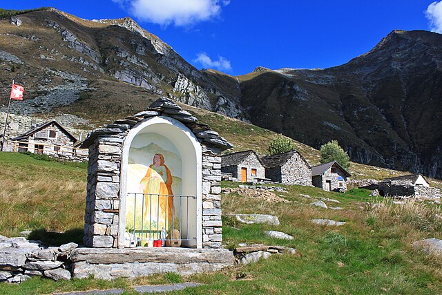 An "Alp" refers to a high elevation pasture frequented only in summer. It often includes several huts and small places of worship (here the Alpe Bardu