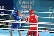 Deutsch: Boxen bei den Olympischen Jugendspielen 2018 Tag 12, 18. Oktober 2018 - Kampf um Bronze im Leichten Weltergewicht Jungen – Hassan Azim (Großbritannien, rot) schlägt Mohammed Boulaouja (Marokko, blau) RSC; Ringrichter ist Wulfren Olivares Peréz (Kolumbien). English: Boxing at the 2018 Summer Youth Olympics on 18 October 2018 – Bronze Medail Match Light Welterweight Boys - Hassan Azim (Great Britain, red) beats Mohammed Boulaouja (Morocco, blue) RSC; Referee is Wulfren Olivares Peréz (Columbia). Español: Boxeo en los Juegos Olímpicos Juveniles de Verano de 2018 en 18 de octubre de 2018 - Medalla de bronce de los hombres ligeros de peso welter: Hassan Azim (Gran Bretaña, rojo) vence a Mohammed Boulaouja (Marruecos, azul) RSC; El árbitro es Wulfren Olivares Peréz (Colombia).