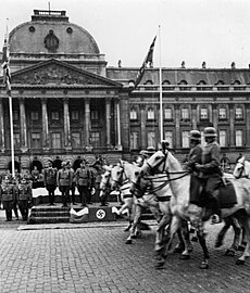 German soldiers parade past the palace, May 1940