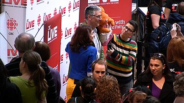 Eisner (in striped shirt) puppeteering Mamma Yamma at a CBC promotional event. CBC Live at Sherway Kids CBC.jpg