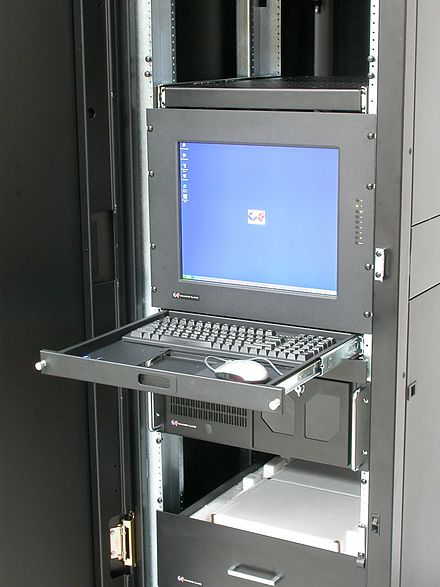 Computer keyboard and monitor mounted on a sliding tray in a rack