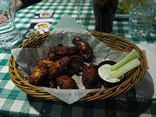 Buffalo wings with garlic dip and celery, along with a glass of Coca-Cola. Chicken wings at O'Learys.jpg
