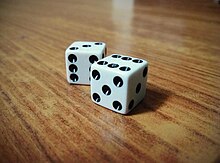 The pips on the top faces of these dice can be quickly counted as totalling 9 Dice on the table six and five.jpg