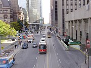 A streetcar travels west along Queen Street West in downtown Toronto.