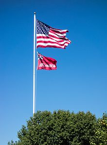 The flag of Taunton flies beneath the flag of the United States over Taunton Green in September 2016. Flag of Taunton, Massachusetts.jpg