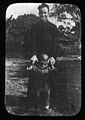 Fr. Taggart, MM, holding a child's hands, China, ca. 1918-1938 (MFB-LS0264).jpg