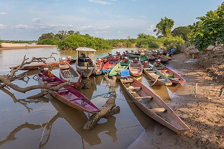 Group of pirogues at sunset on the river bank of Don Tati, Si Phan Don, Laos