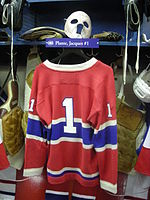 Goaltender Jacques Plante's No. 1 jersey exhibited at the Hockey Hall of Fame. Over time, the number 1 became less common among players in that position. HHOF July 2010 Canadiens locker 15 (Plante).JPG
