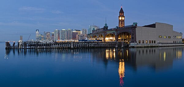 Hoboken Terminal viewed from the northeast, with Jersey City skyline in the background Hoboken Terminal June 2015 panorama 1.jpg