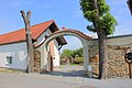 Archway to a courtyard entrance with a wall on the side