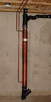 Installation of a double-walled copper-on-copper heat exchanger in a vertical section of the master drain line in a Canadian home (2007) Hot water heat recycling unit.jpg